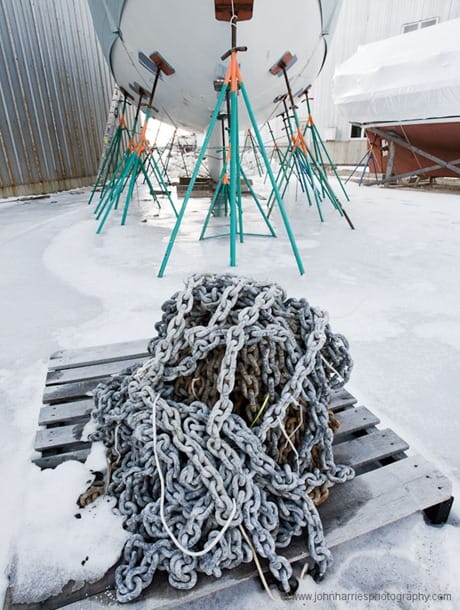 "Morgan's Cloud" on the hard at Billings Diesel and Marine in Stonington, Maine, with a pile of anchor chain frozen to a pallet at her bow during one of the three winters we spent at Billings refitting the boat.