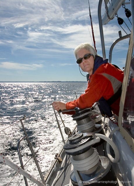 Phyllis Nickel takes a turn on the jib sheet during a sunny summer afternoon off the east coast of Newfoundland, Canada.