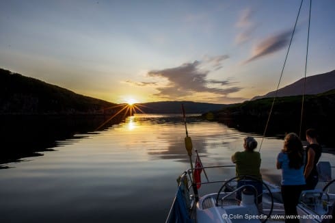 The crew watch the sunset from Soay Harbour